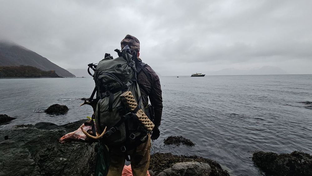 Hunter glassing the shoreline from the Alaska coast